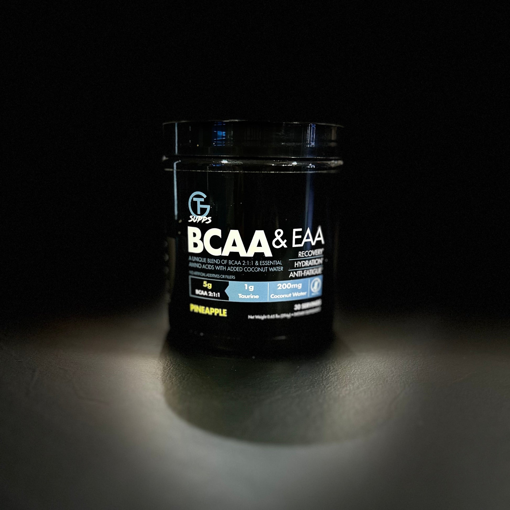 Black supplement container labeled 'BCAA & EAA' on a dark background